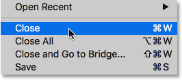 Choose the Close command from the File menu in Photoshop.
