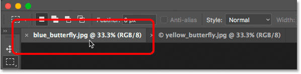 Clicking tabs to switch between grouped documents in Photoshop.