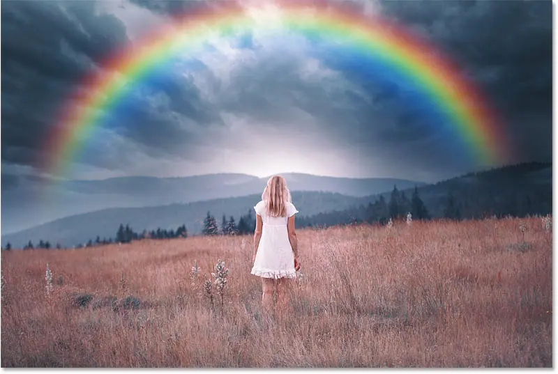 Efecto arco iris en Photoshop con parte del arco iris escondido detrás de la colina