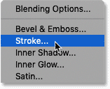 Choosing Stroke from the Layer Effects menu in the Layers panel in Photoshop